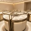 curved display cabinet (2) Round Hollow Jewelry Display Island with Zoned Curved Glass | Luxury Champagne Gold Modular Retail Showcase with Lockable Storage for USA & Australia Jewelry Stores
