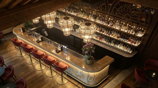 vintage curved onyx stone bar counter with arched metal wine rack for retro restaurant and whiskey lounge