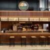 retro walnut wood curved craft beer bar counter with suspended light canopy for brewpub and gastropub