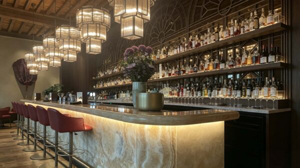 vintage curved onyx stone bar counter with arched metal wine rack for retro restaurant and whiskey lounge