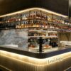 custom shop bar counter-3d design-lexio display (4) modern luxury fluted bar counter with back wall wine rack dark marble top for hotel restaurant lounge