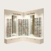 L-Shaped Corner LED Sunglasses Display Wall Unit | Recessed Backlit Eyewear Wall Cabinet With Decor Mirrors, Custom 3D Logo & Locked Drawer Base For Modern Optical Store Interior Design