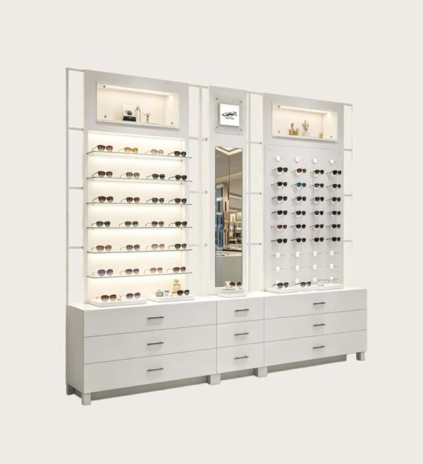 Custom Full White Modular Eyewear Wall Display System | LED Lit Multi-Style Optical Frame & Sunglasses Display Wall With Central Mirror, Large Drawer Storage Base & Decor Niche Shelves For Optical Shop Interior Design