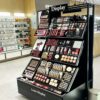 perfume display cabinet (21) Black Metal Frame Tiered Makeup Display Stand | Cosmetic Gondola Showcase For Beauty Retail