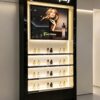 perfume display showcase (10) Tall Gloss Black Perfume Wall Display Unit | Slim Vertical Fragrance Showcase With LED Shelf Lights For Stores