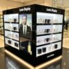 Factory Gloss Black Gondola Perfume Display | Commercial Multi-Side Fragrance Gondola Showcase With LED Shelves & Poster For Cosmetic Shop