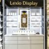 Wholesale Perfume Store Wall Display Cabinet | White Luxury Fragrance Counter Showcase With Central Backlit Poster & Drawer Storage