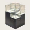museum display cabinet (1) Staggered multi-tier frameless glass jewelry island display cabinet with matte dark base Lexio Display for luxury jewellery boutique retail