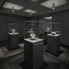 museum display cabinet (11) Frameless ultra-clear glass display case with matte dark square pedestal Lexio Display for sculpture and stone artwork exhibition