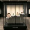 museum display cabinet (2) Freestanding glass museum display case with multi-height tiered platforms and black frame Lexio Display for ceramics, pottery and antique artifact exhibition