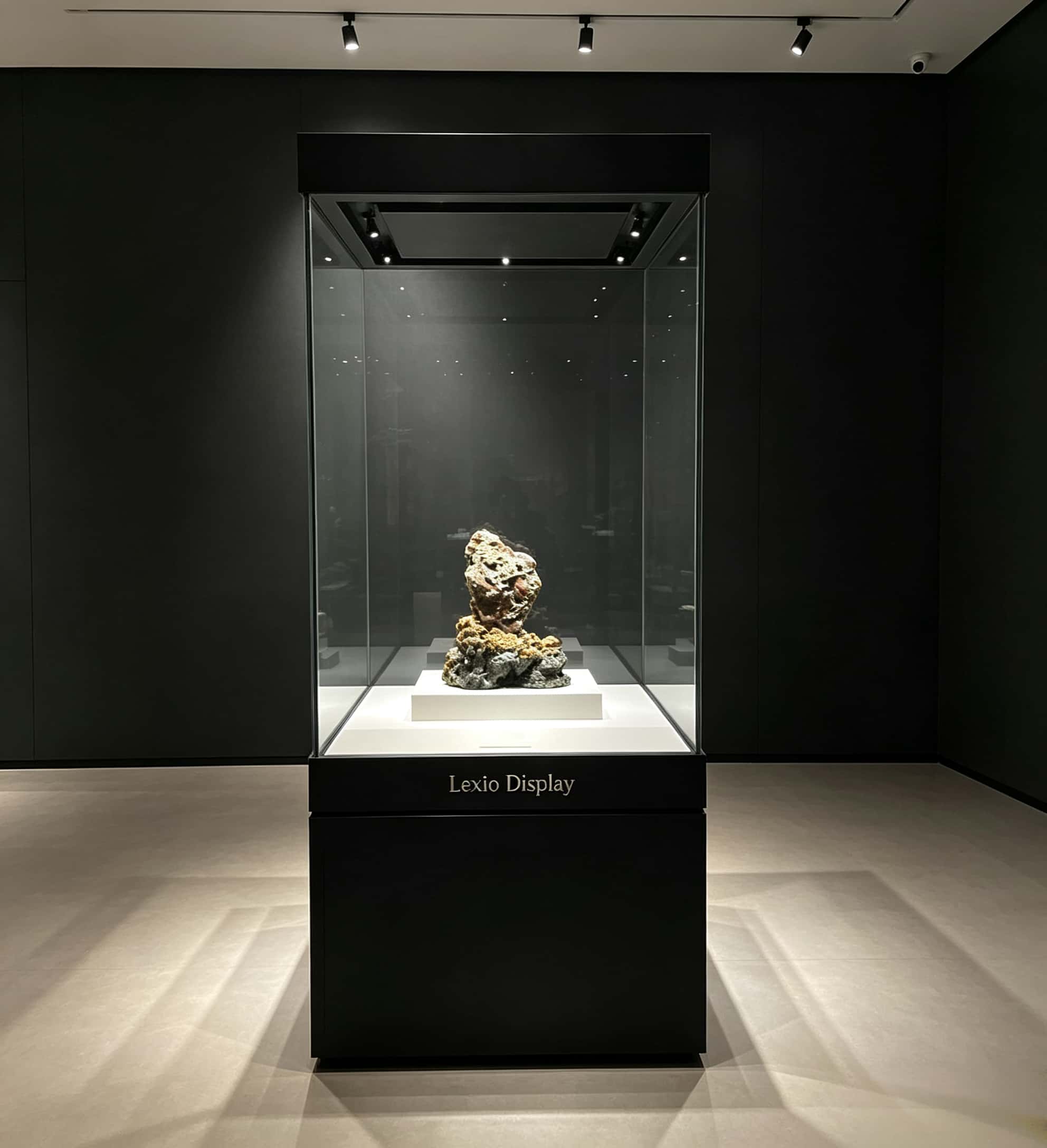 All-black integrated tall museum display vitrine with storage base and top recessed LED lights Lexio Display for mineral specimen and cultural relic exhibition