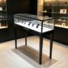 Black tall four leg pedestal glass phone display case LED light base mobile phone showcase counter Lexio Display