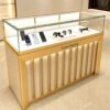 phone display cabinet (27) Luxury gold vertical slat glass display counter built‑in LED lighting lockable custom Lexio Display logo for watch and electronics store