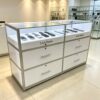 phone display cabinet (3) White dual compartment glass mobile phone island display counter with LED light and lockable drawers Lexio Display