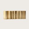 Custom vertical fluted ribbed brushed gold reception desk long wavy lobby front counter Lexio Display