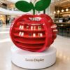 Custom Gloss Red Apple Sculpture Display Stand Multi-Layer Open Shelves With Leaf Decor White Round Base For Cosmetic Beverage Brand Shopping Mall Exhibition Pop-Up