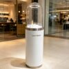 retail display stands (2) Luxury white cylindrical pedestal display stand with dome clear glass cover and built-in LED light, Lexio Display for perfume, jewellery and high-end cosmetic boutique