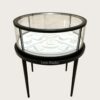 Round glass top jewelry display showcase black metal frame tapered legs white velvet interior Lexio Display for luxury jewellery boutique retail