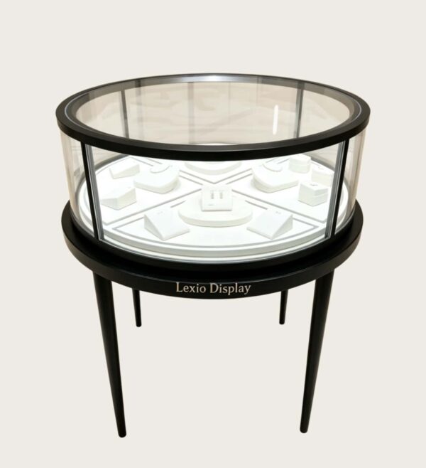 retail display stands (6) Round glass top jewelry display showcase black metal frame tapered legs white velvet interior Lexio Display for luxury jewellery boutique retail