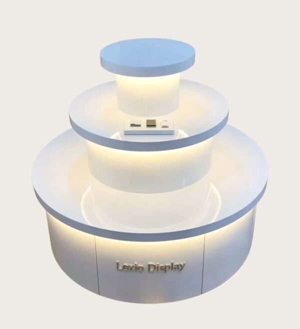Light blue white three-tier cylindrical LED glowing retail island display stand Lexio Display for electronics cosmetic boutique and mall pop-up showcase