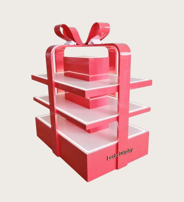 retail display stands (8) Glossy red gift box shaped three-tier LED lighted retail island display stand with decorative bow Lexio Display for mall seasonal holiday gift promotion