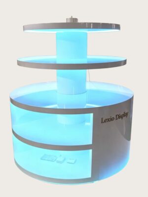 retail display stands (9) Round three-tier LED lighted retail island display stand white glossy with glowing base shelves Lexio Display for shopping mall cosmetics and electronics promotion
