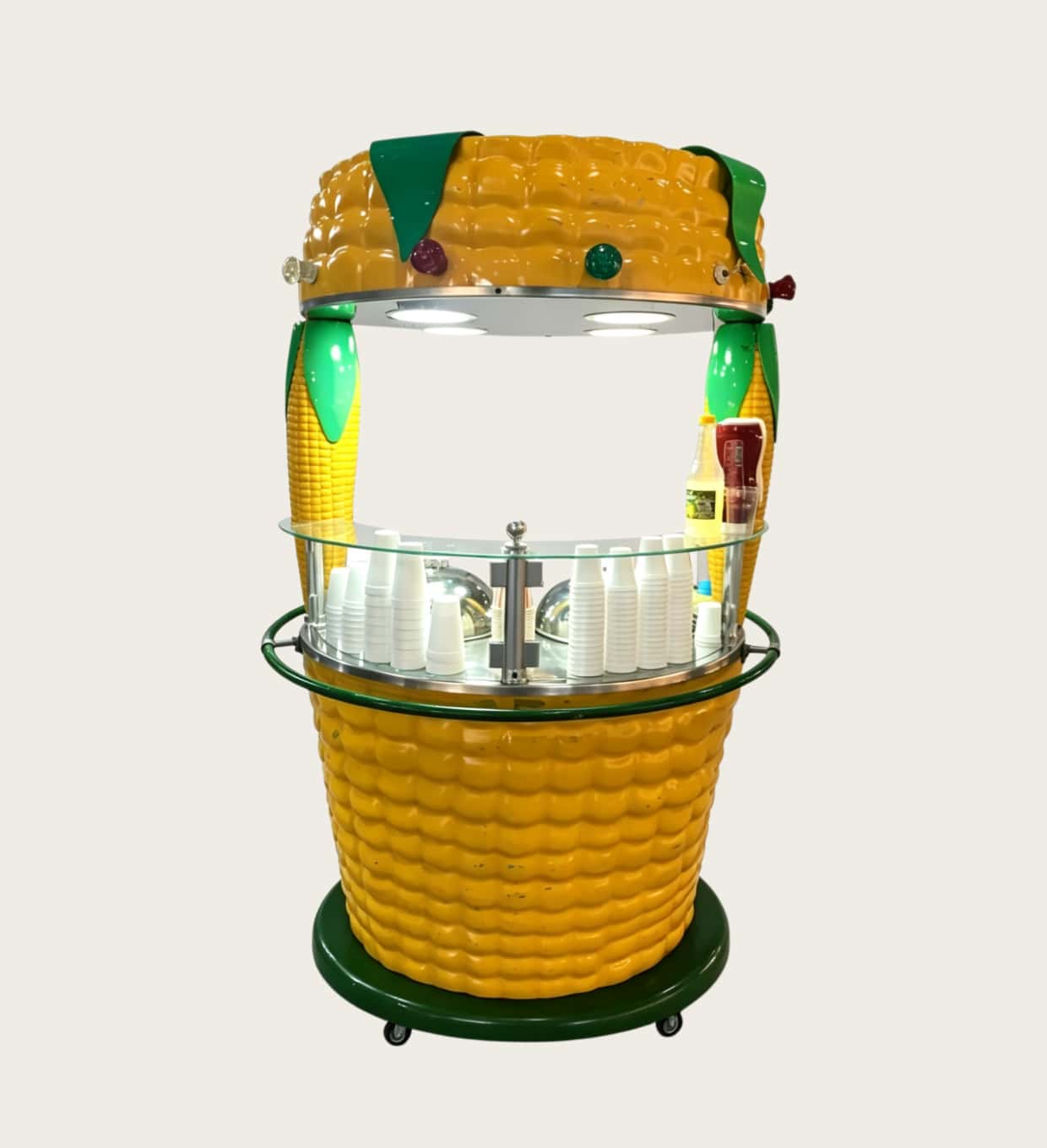 Giant corn‑cob shaped fiberglass mobile food vending cart, open‑top corn themed kiosk with glass counter, LED lights and wheels Lexio Display for fairgrounds and amusement park