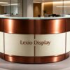 U‑curved circular office reception desk with brushed copper metal framing, cream lacquer panels and clear tempered glass top, modern corporate lobby front counter Lexio Display