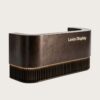 U‑shaped curved aged bronze reception desk with vertical fluted base and warm LED strip lighting, luxury lobby front counter Lexio Display for premium commercial interior fit‑out