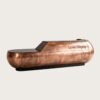 Sculptural capsule‑shaped aged copper reception desk with rounded bulbous ends and integrated top LED strip, large luxury lobby front desk Lexio Display for high‑end commercial fit‑out