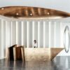 Origami‑style folded metal irregular luxury reception desk, artistic lobby front counter Lexio Display for modern high‑end commercial interior