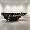 Sculptural fluid crumpled‑form abstract art reception desk, metallic lobby front counter Lexio Display for gallery and high‑end commercial interior