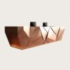 reception desk (24) Faceted geometric rose‑gold reception desk with ambient LED backlight, multi‑person lobby counter Lexio Display for modern luxury commercial interior