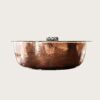 Hammered textured metal bowl‑shaped curved bar reception desk with glass top, luxury lobby bar counter Lexio Display for high‑end hospitality project