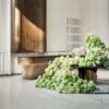Brushed bronze curved reception desk with natural marble top, solid‑body luxury lobby counter Lexio Display for premium hotel and corporate project