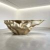 Sculptural fluid crumpled‑form abstract art reception desk, metallic lobby front counter Lexio Display for gallery and high‑end commercial interior