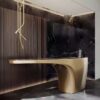 Fluid cantilever curved gold sculptural reception desk, floating‑top lobby front counter Lexio Display for premium hotel and corporate interior