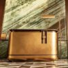 reception desk (4) Antique brass rounded luxury reception desk with marble top, metal hotel lobby front counter Lexio Display for high‑end commercial interior fit‑out
