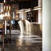 Origami‑style folded metal irregular luxury reception desk, artistic lobby front counter Lexio Display for modern high‑end commercial interior