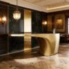 Fluid cantilever curved gold sculptural reception desk, floating‑top lobby front counter Lexio Display for premium hotel and corporate interior