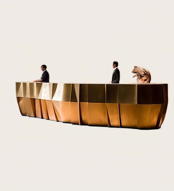 Large geometric faceted metal‑panel multi‑person reception desk, luxury hotel lobby front counter Lexio Display for high‑end commercial interior