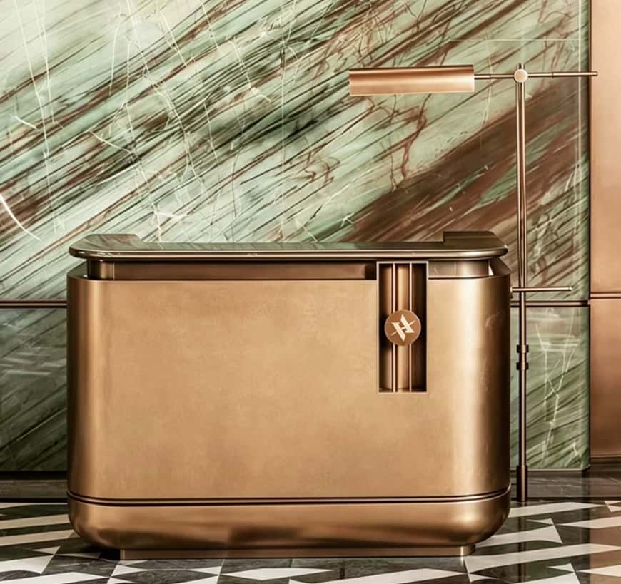 Antique brass rounded luxury reception desk with marble top, metal hotel lobby front counter Lexio Display for high‑end commercial interior fit‑out
