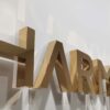 Close-up of thick brushed gold stainless steel 3D letter side profile