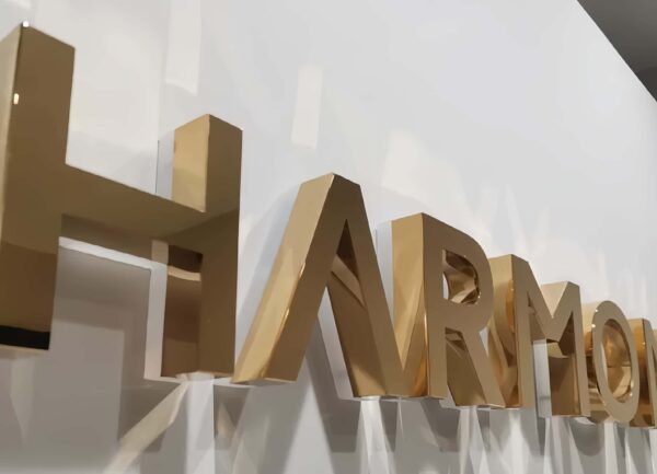 Close-up of thick brushed gold stainless steel 3D letter side profile
