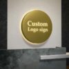 Custom circular LED backlit business wall sign, mirror gold stainless steel panel with glowing cutout logo