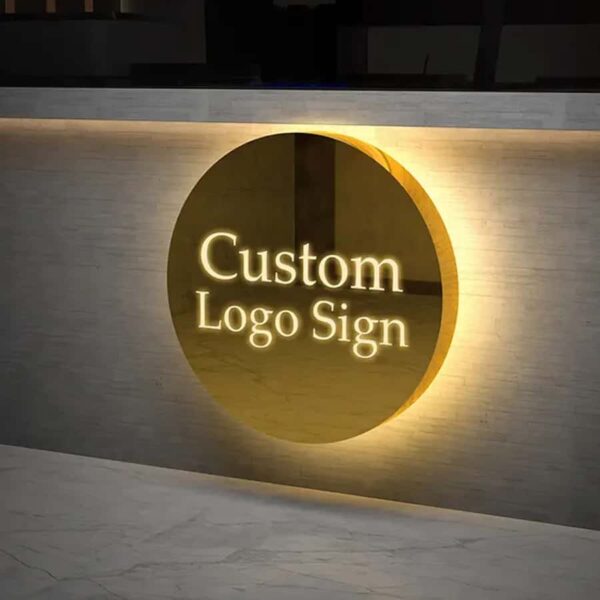 Custom round backlit metal logo sign on textured brown lobby wall, warm halo backlight