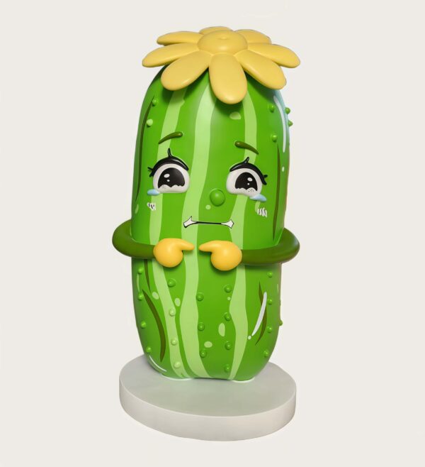 Customized fiberglass display (15) Factory shot cartoon cucumber fiberglass mascot sculpture with crying face, yellow flower on top, paired with red chili character statue in workshop