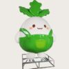 Factory workshop photo of cartoon white radish fiberglass mascot sculpture, cute chibi radish character with green top leaves and green overalls