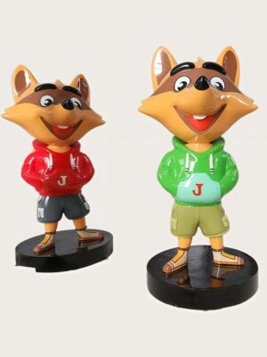 Factory workshop photo of two cartoon raccoon fiberglass mascot sculptures, red hoodie and green hoodie raccoon characters standing on black round bases