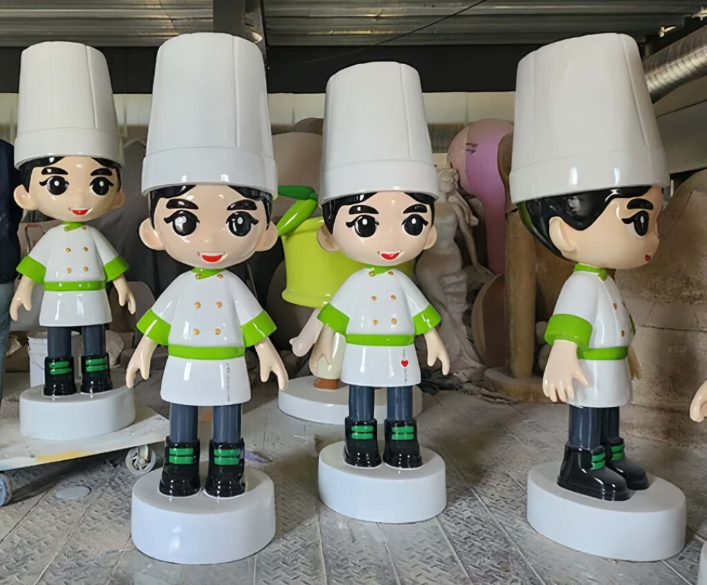 Close-up shot of glossy FRP catering IP mascot statue, cute cartoon chef standing on white round base for restaurant entrance photo spot